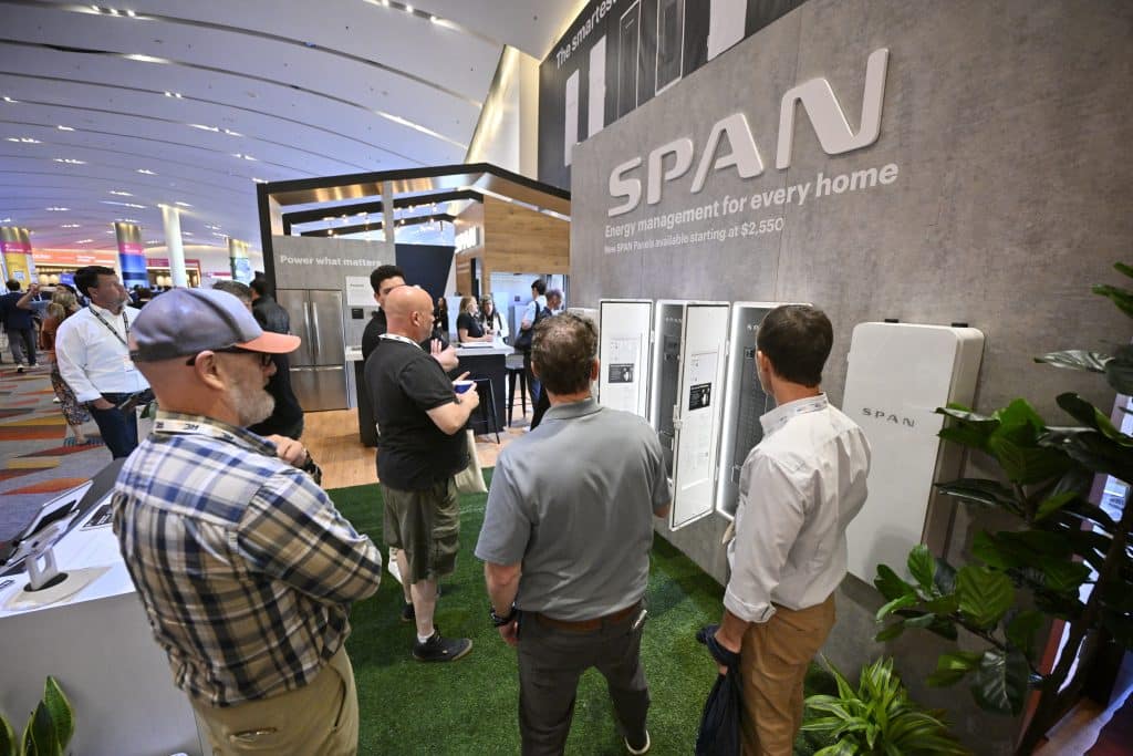RE+ 25 attendees view SPAN energy management products at an exhibitor booth