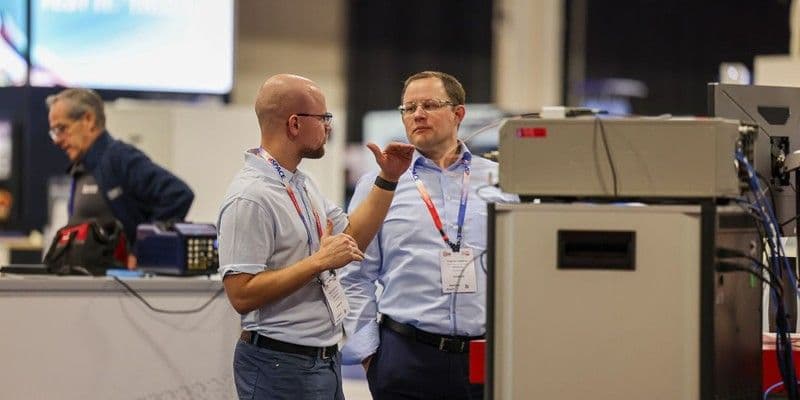 Engineers discussing an exhibit