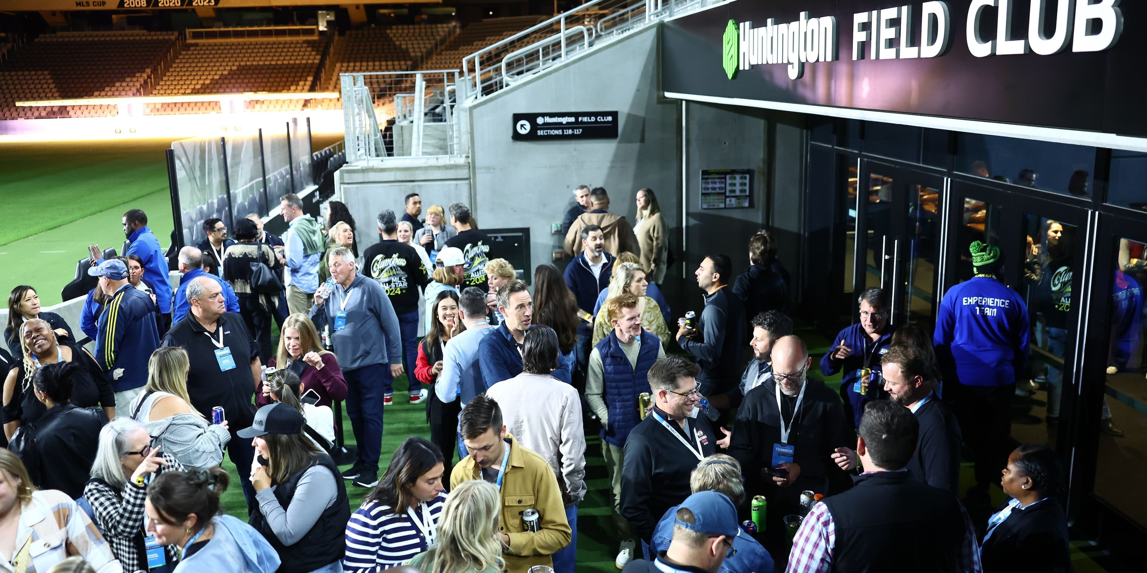 TEAMS 2025 attendees networking at a stadium event