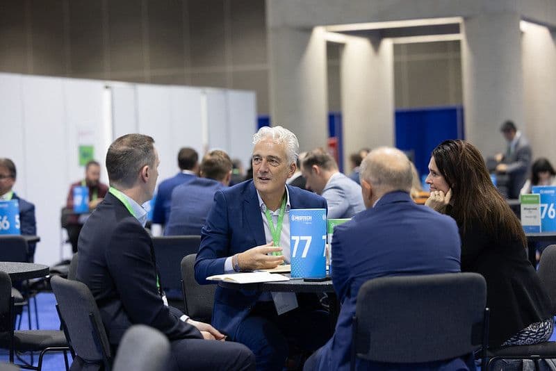 Four attendees meeting at a numbered partnering table during The MedTech Conference 2025