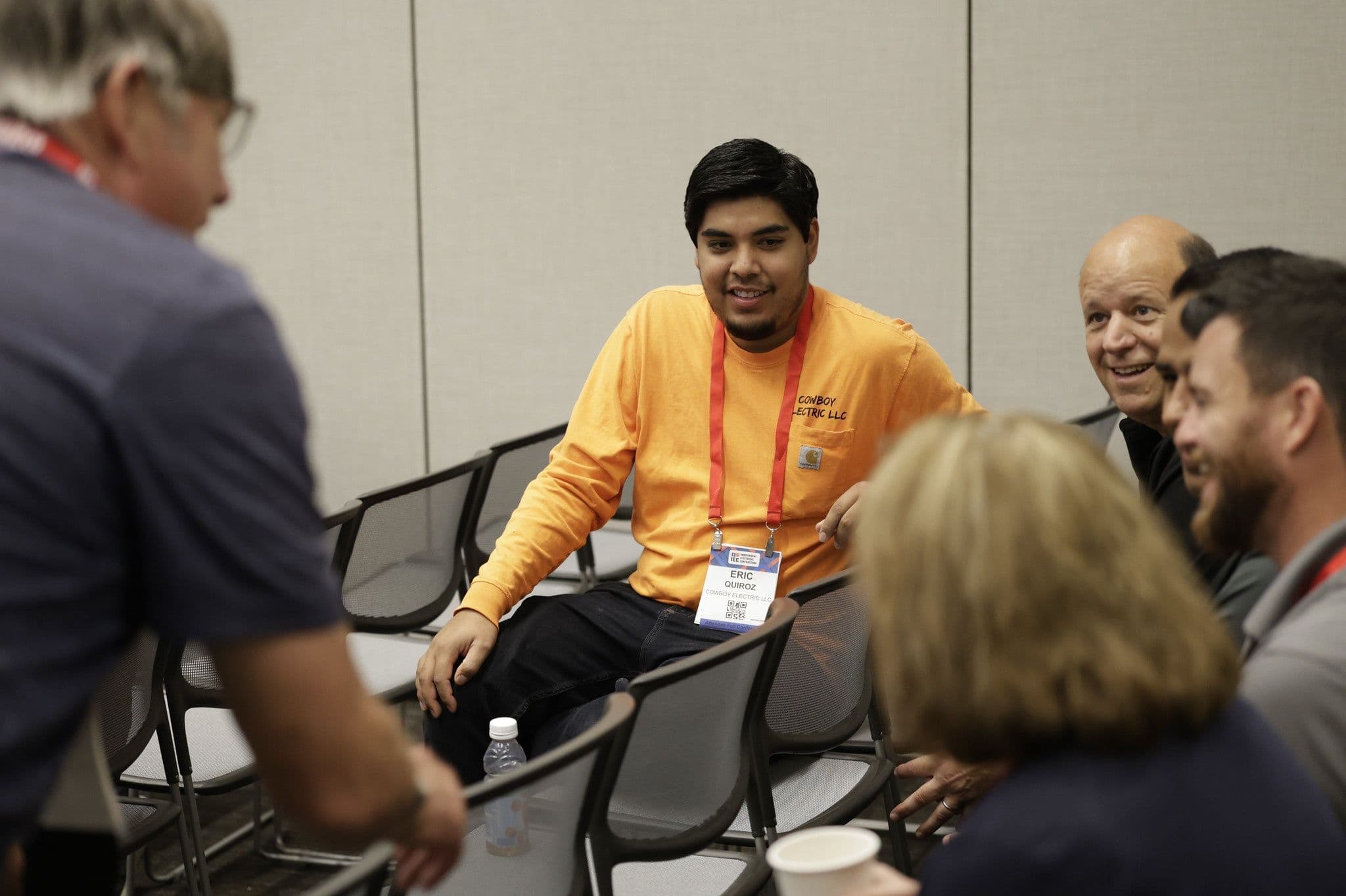 Electrical contractors in a small-group discussion at IEC SPARK
