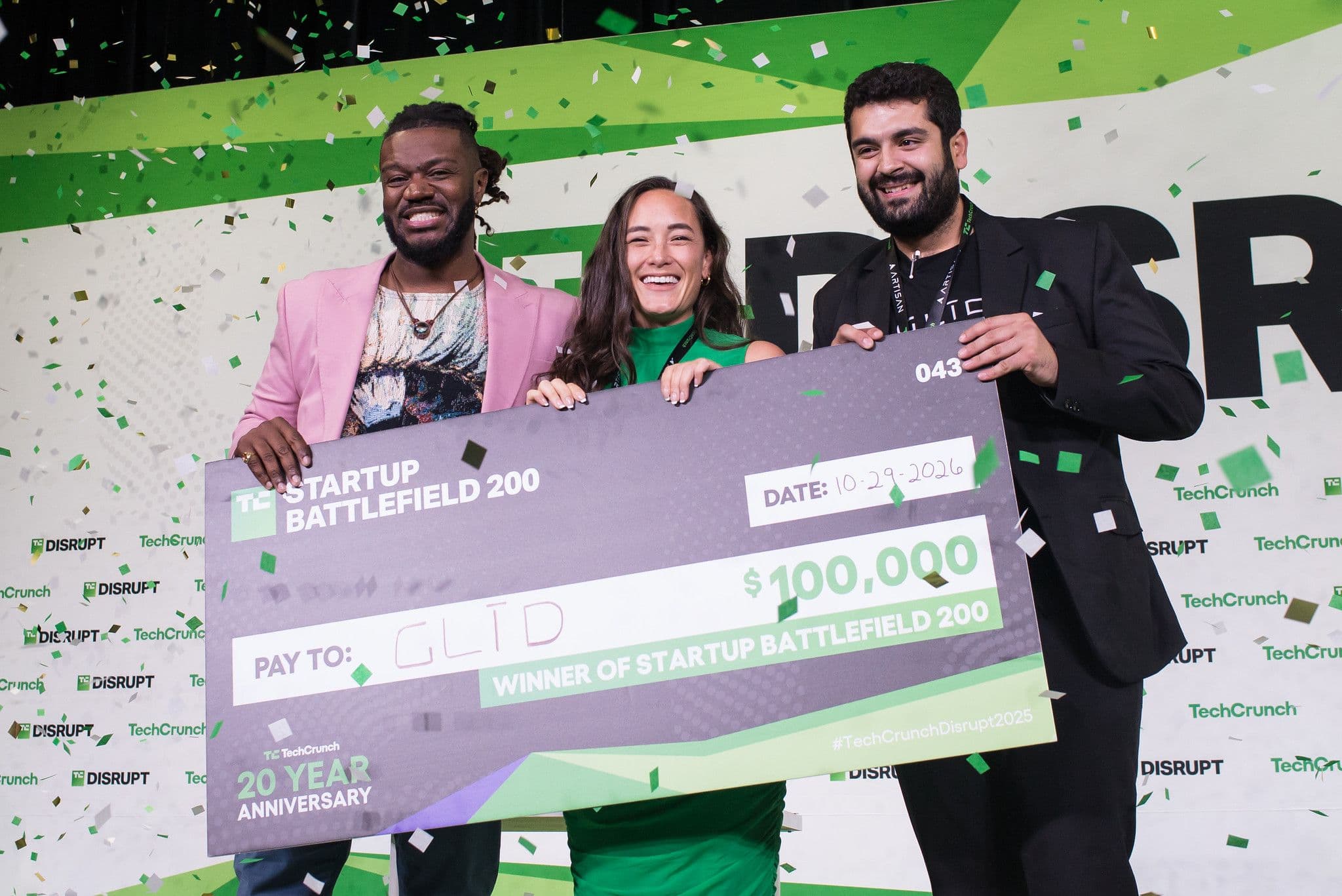 Founders holding the 100,000 dollar Startup Battlefield 200 winner check onstage at TechCrunch Disrupt 2025