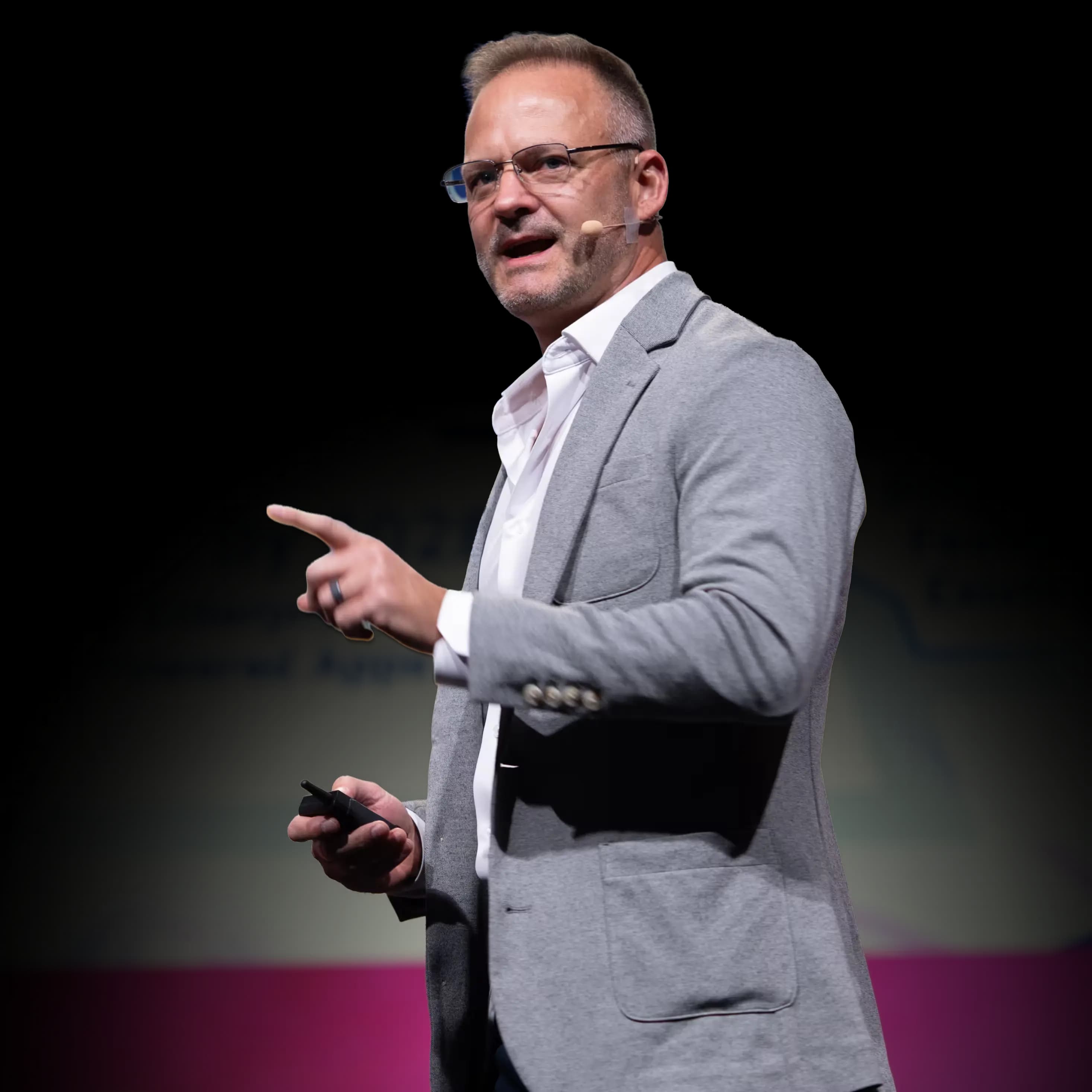 A presenter speaking on stage at a prior Technology & Services World conference edition