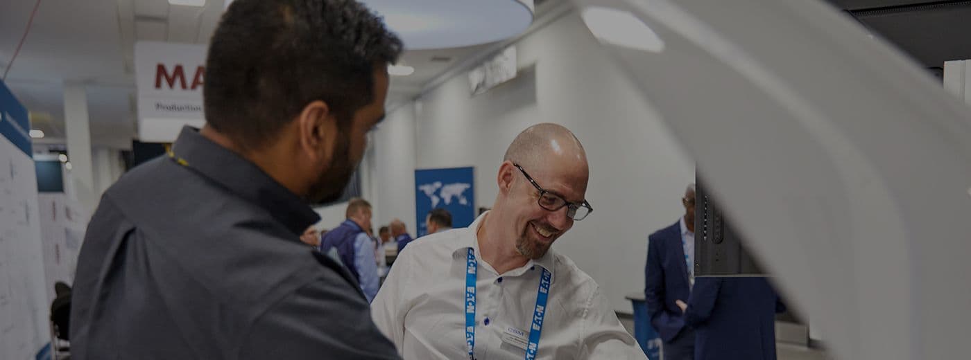 Exhibitor staff meeting attendees at the 2024 EV Tech Expo and Battery Show in Detroit