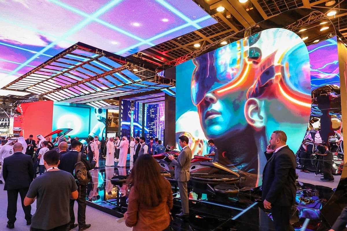 Attendees exploring an immersive LED exhibition stand with large digital artwork at GITEX GLOBAL