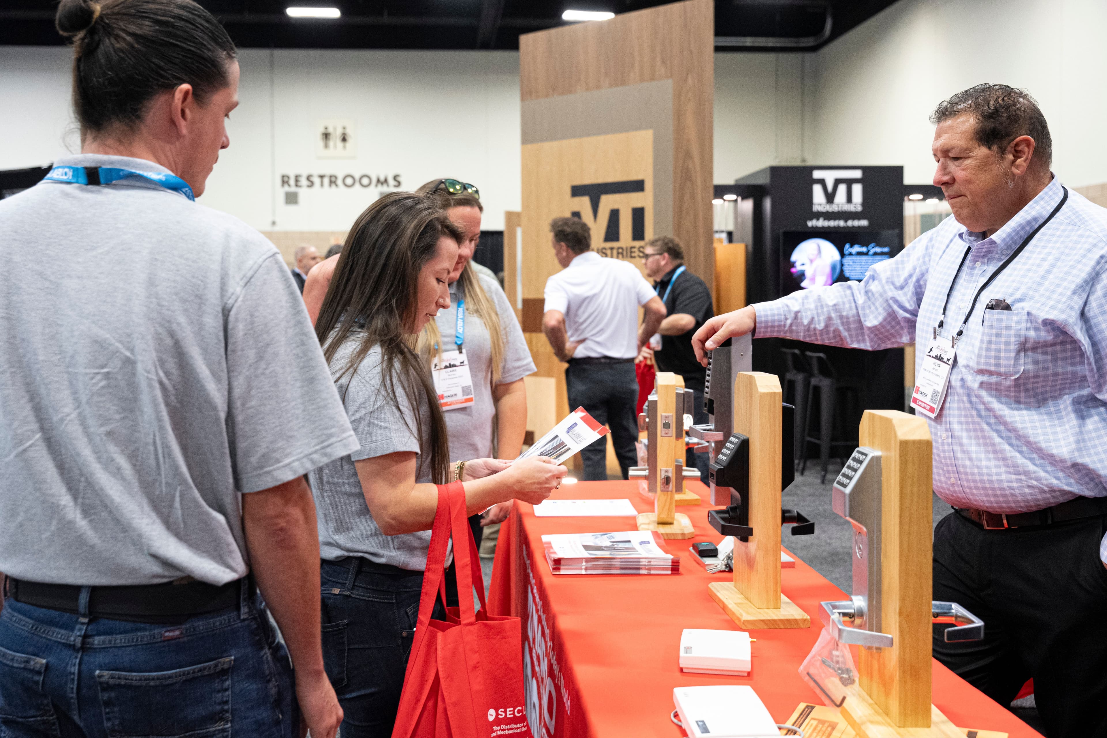 Attendees inspect lock and access-control products at DHI conNextions 2025