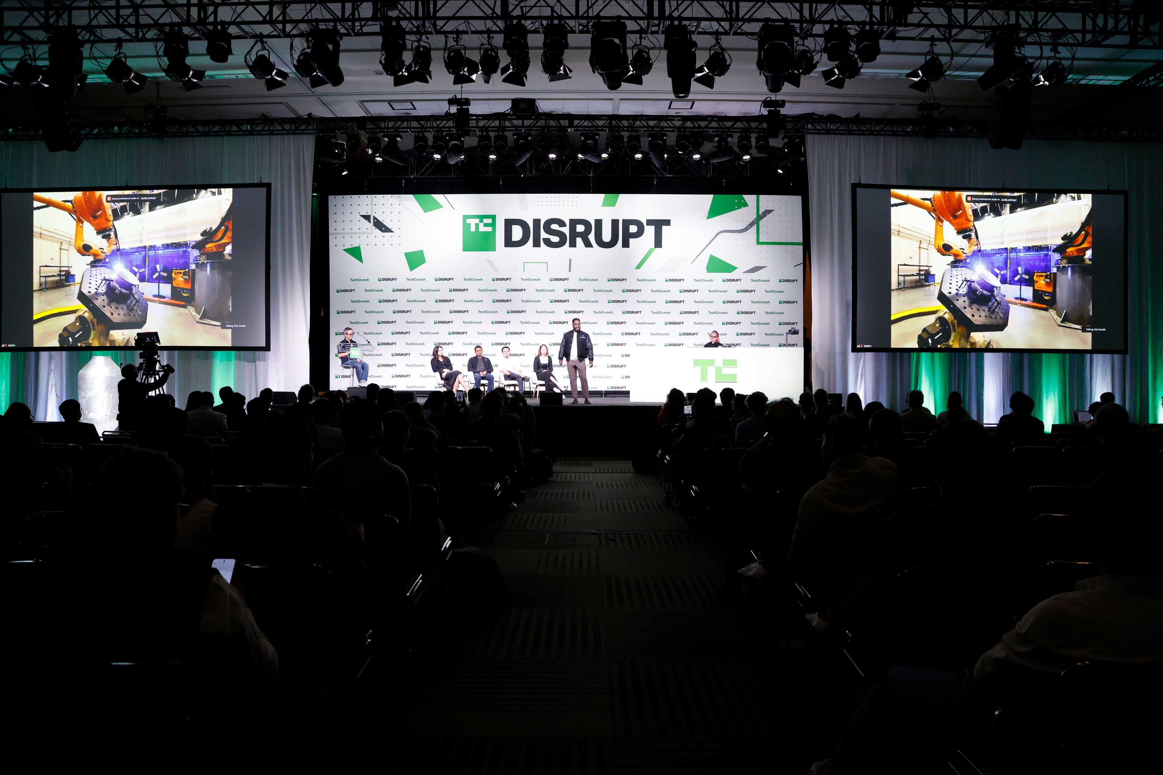 Panel and a speaker on the TechCrunch Disrupt 2024 main stage in front of a seated audience