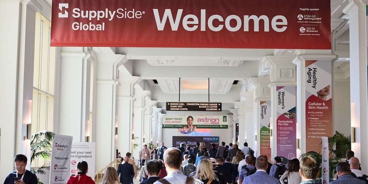 Attendees beneath the SupplySide Global welcome banner at the 2025 event.