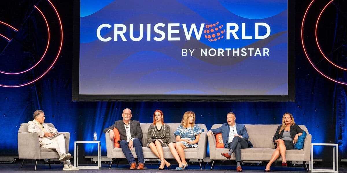 Cruise executives on stage at the CruiseWorld 2025 opening session