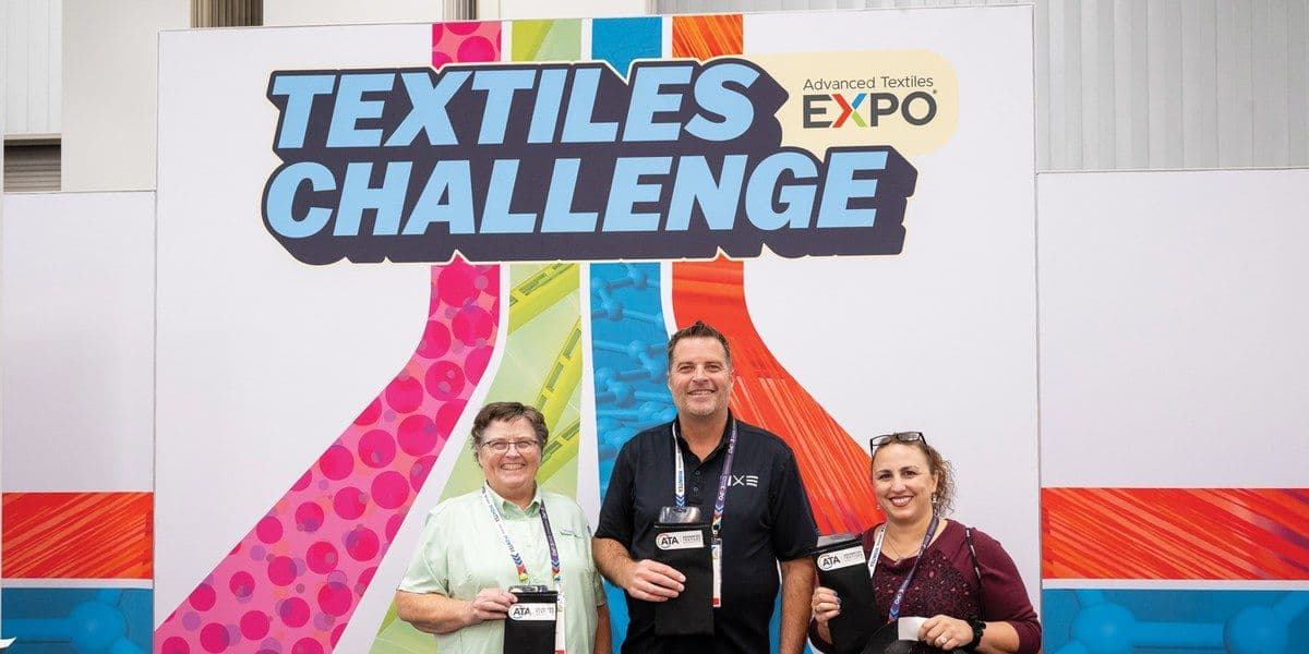 Three participants at the Advanced Textiles Expo 2025 Textiles Challenge display
