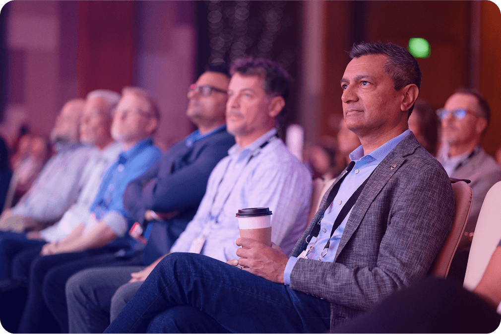 Audience members watching a TSIA World conference session at a prior edition