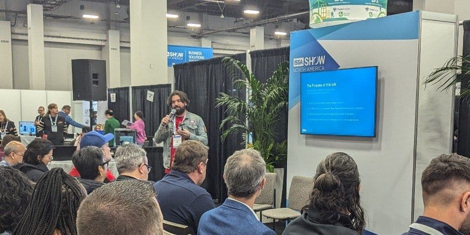 Presenter speaks to a seated audience at a session, 2024 ISSA Show North America
