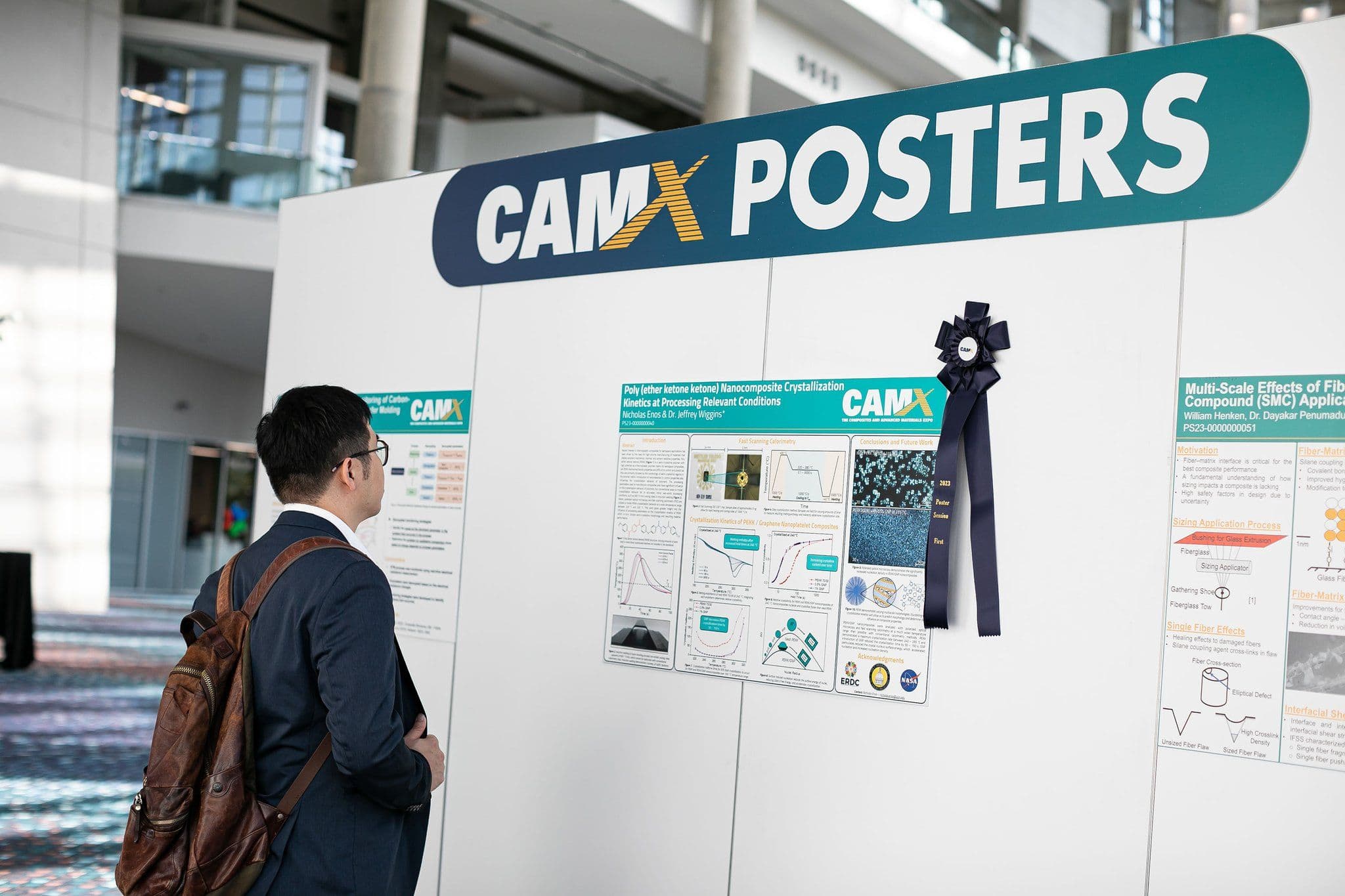 CAMX attendee using B2Brain lead capture while reviewing advanced materials research