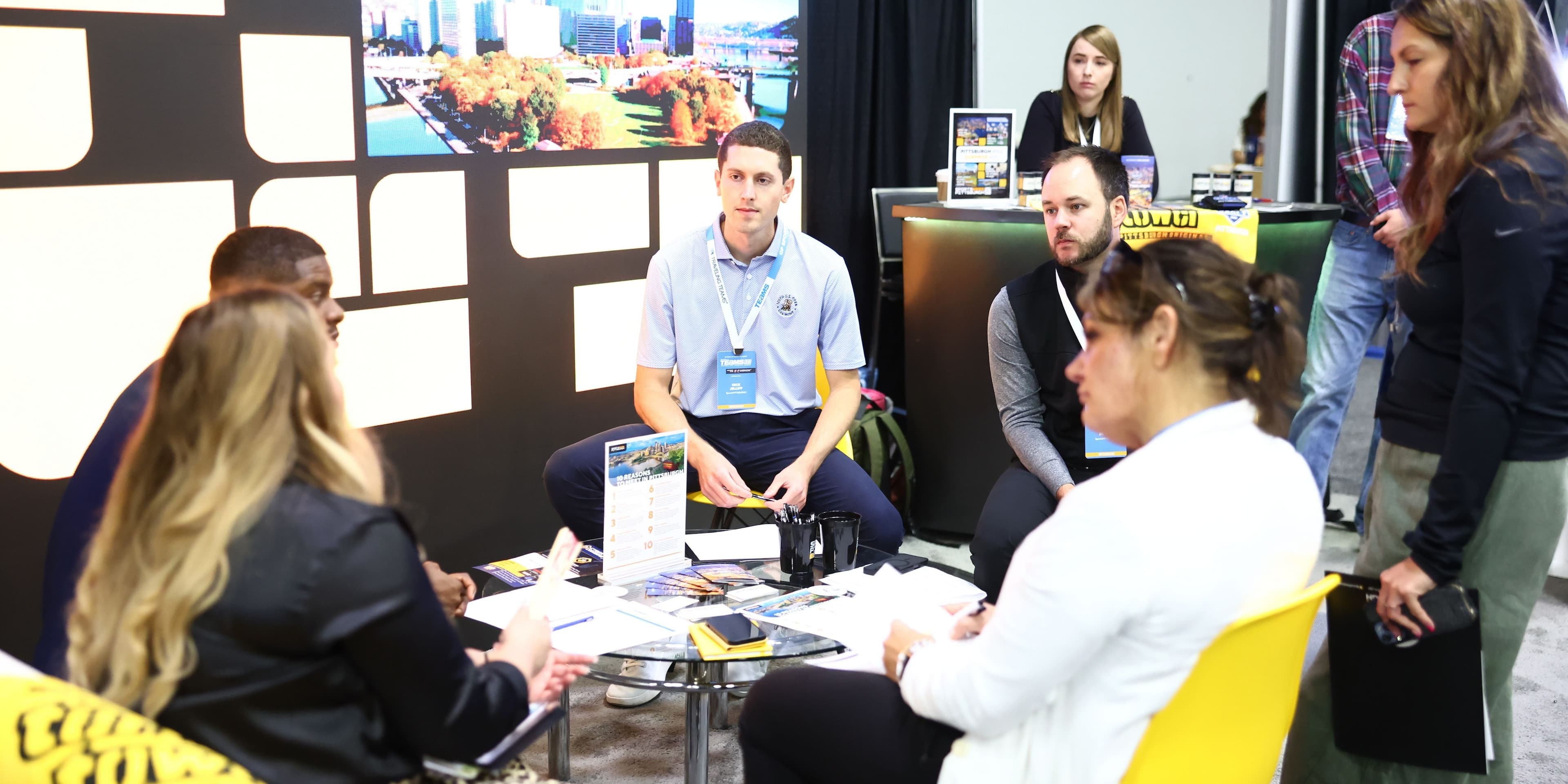 TEAMS 2025 participants meeting at an exhibitor table