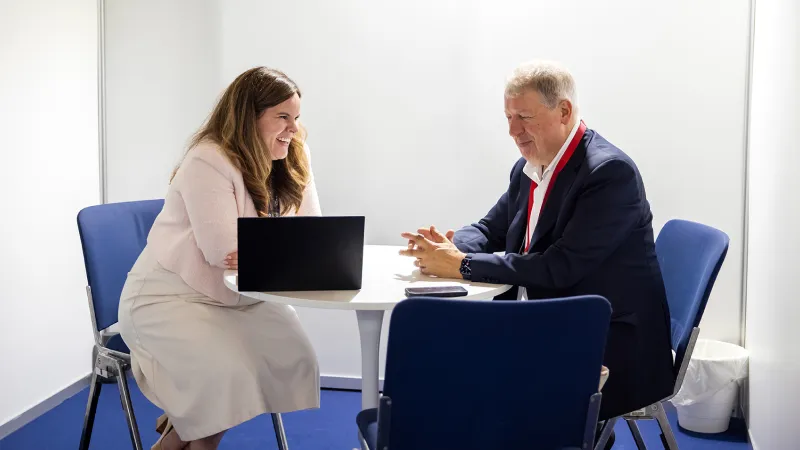 Two attendees in a one-to-one conversation at Gartner IT Symposium/Xpo 2025