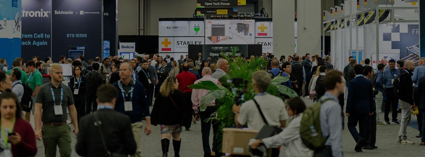 Attendees and exhibitor booths on the EV Tech Expo and Battery Show floor at Huntington Place