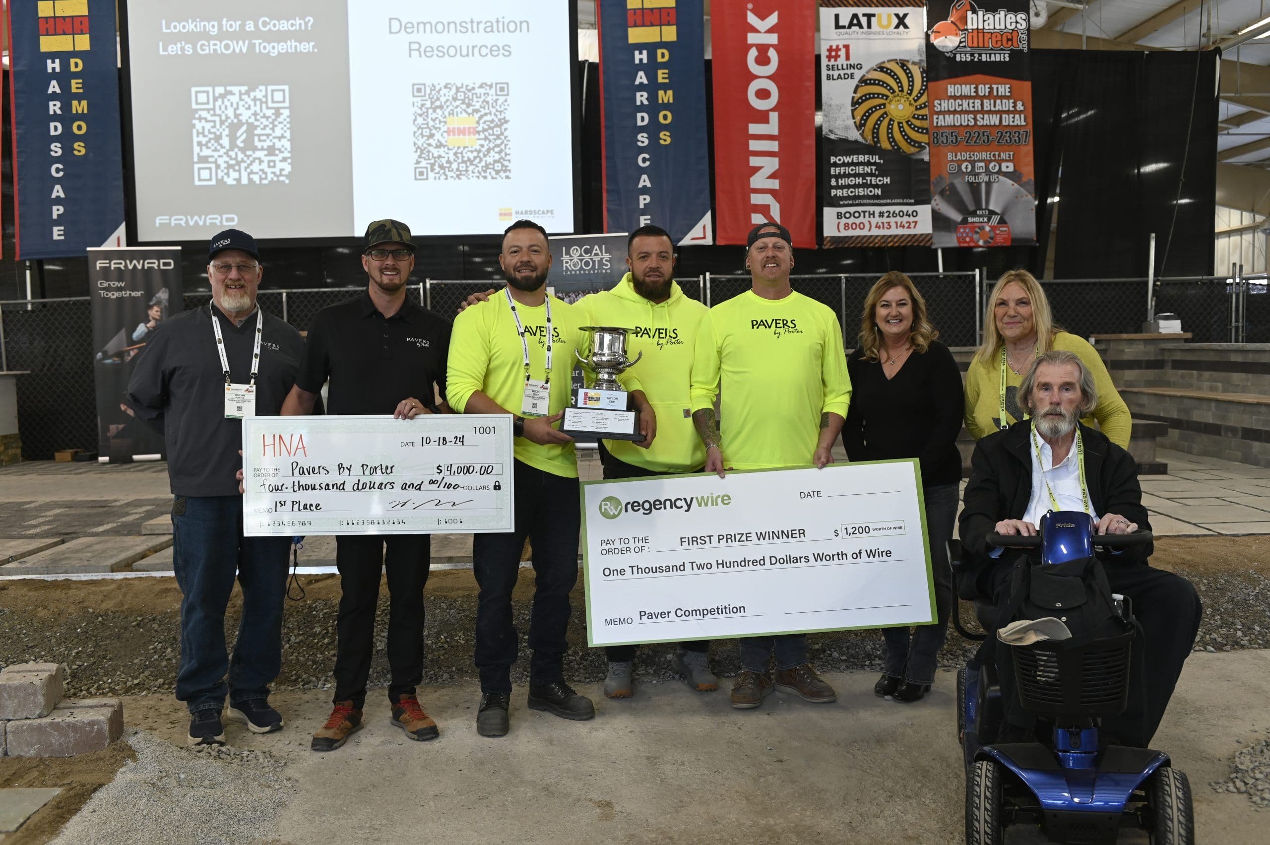 The 2024 HNA installer competition winners pose with their trophy and prize checks inside Hardscape House.