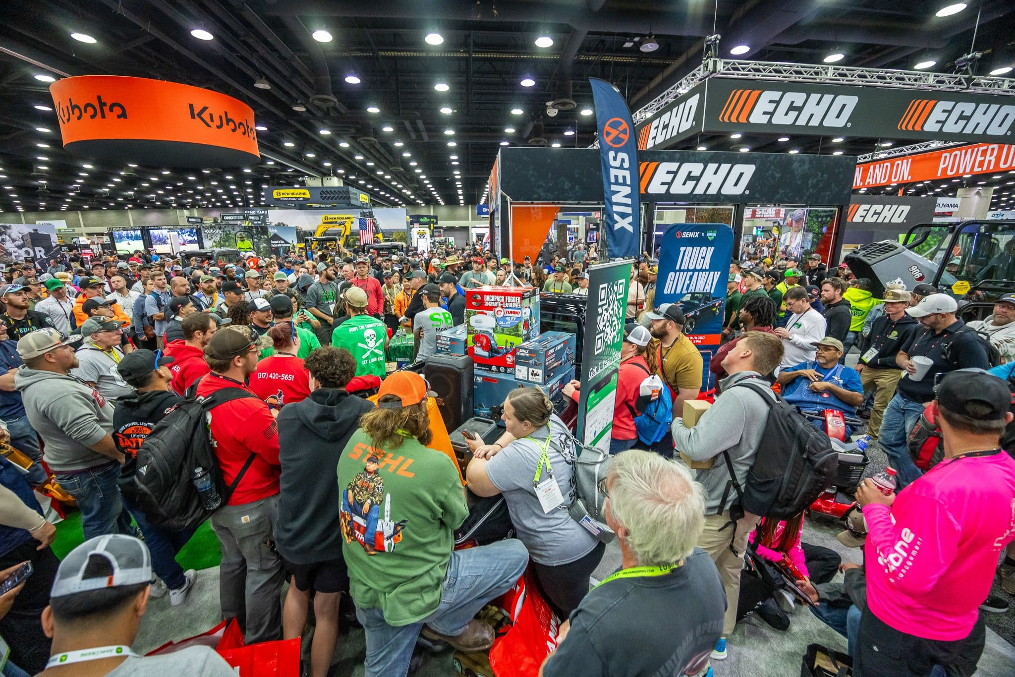 Crowded Equip Exposition 2025 show floor with outdoor power equipment booths and attendees