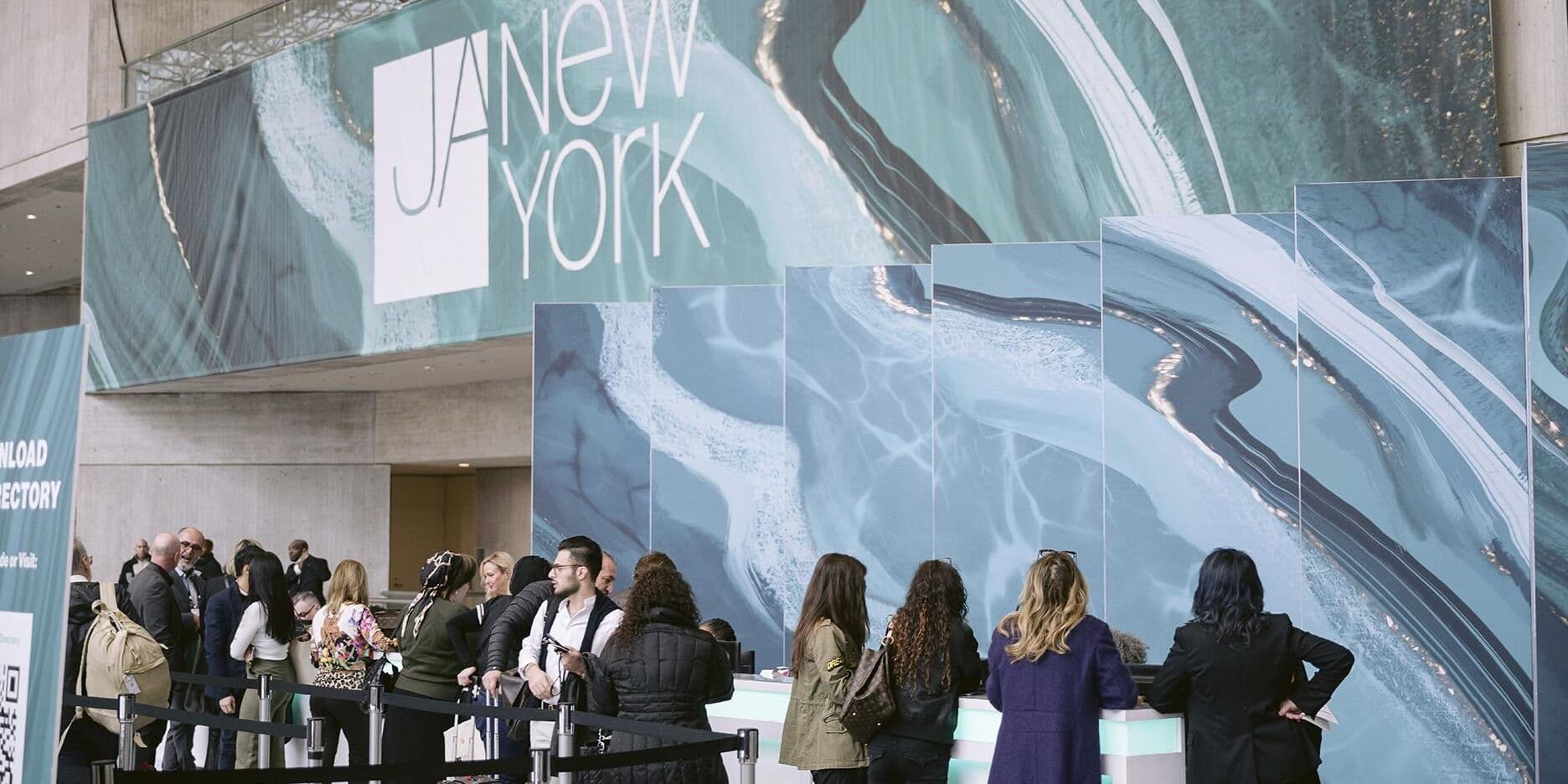 JA New York trade attendees at the branded registration area during a prior Fall edition.