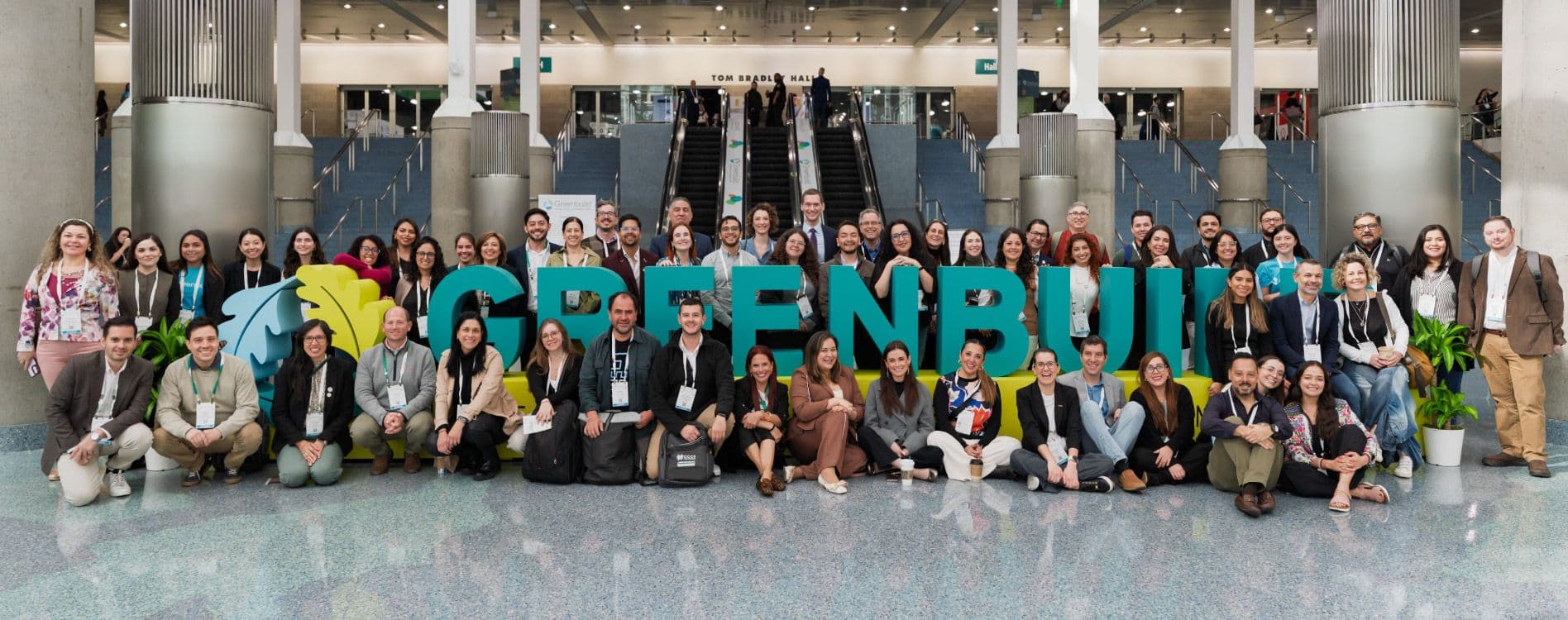 Greenbuild 2025 attendees gathered beside the event sign