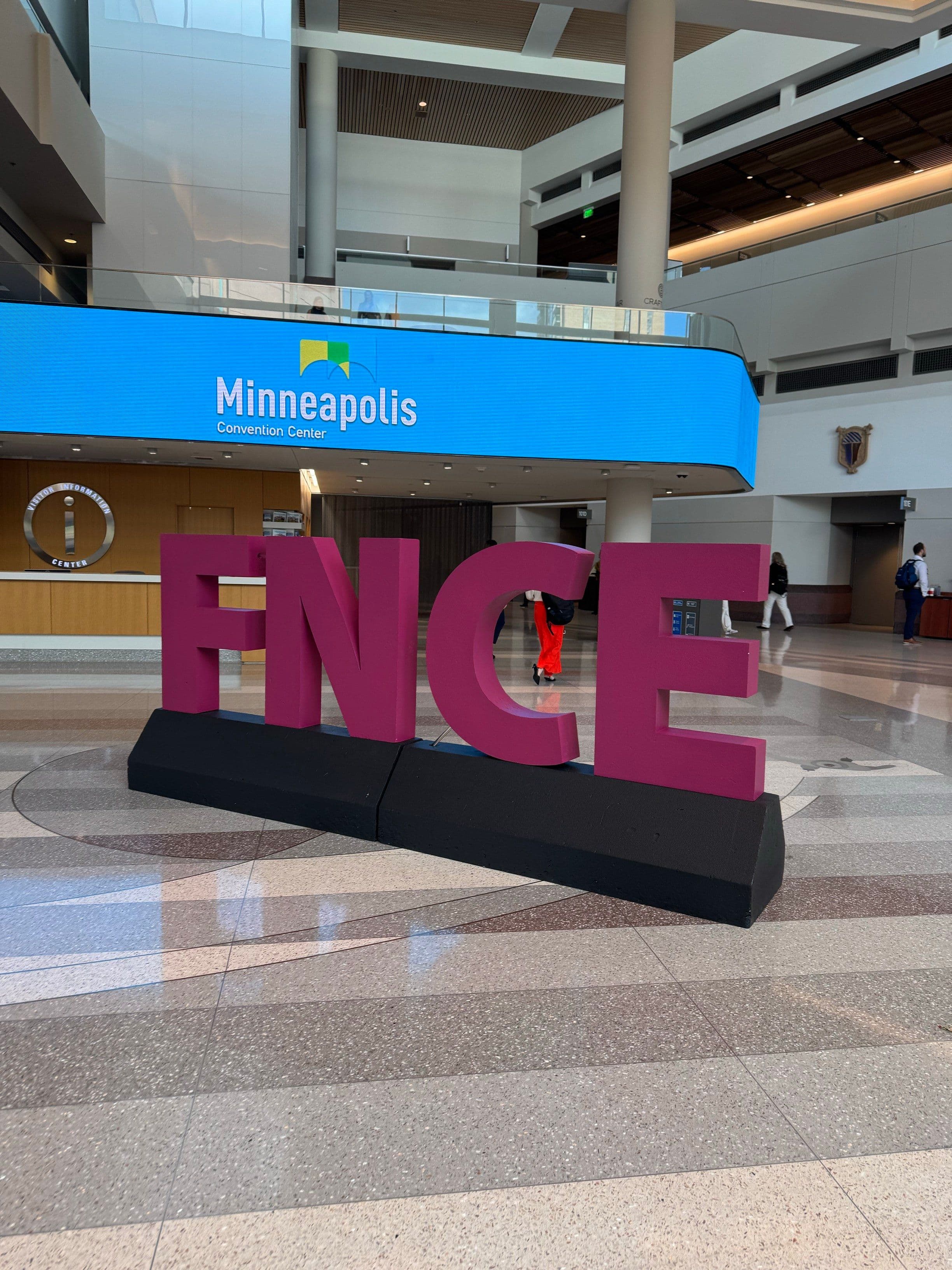 Large magenta FNCE letters inside the Minneapolis Convention Center during FNCE 2024