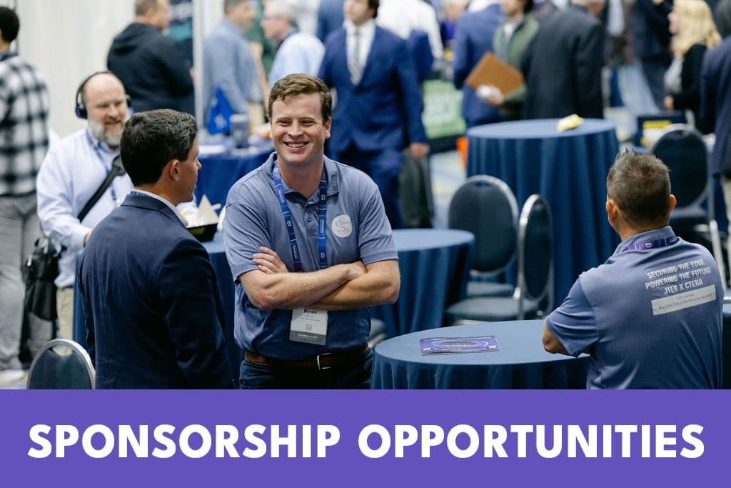 Billington CyberSecurity Summit attendees discussing an exhibitor offering on the show floor