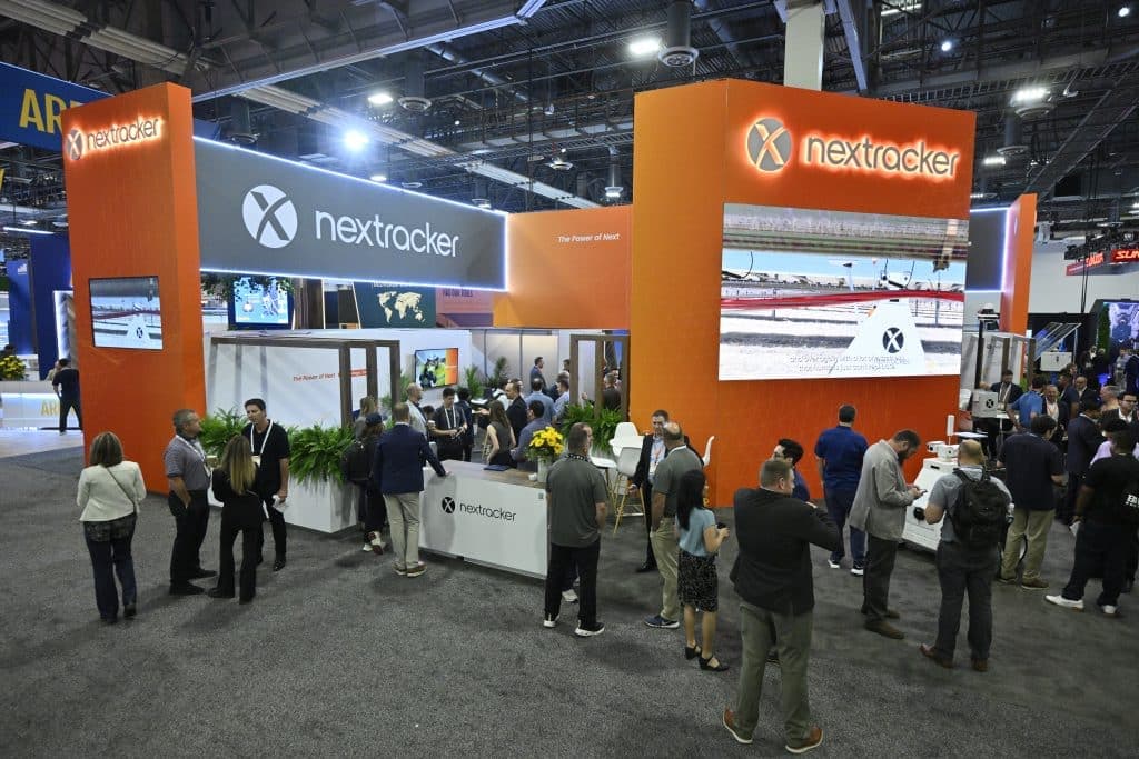 Attendees gather at the Nextracker booth on the RE+ 25 show floor in Las Vegas