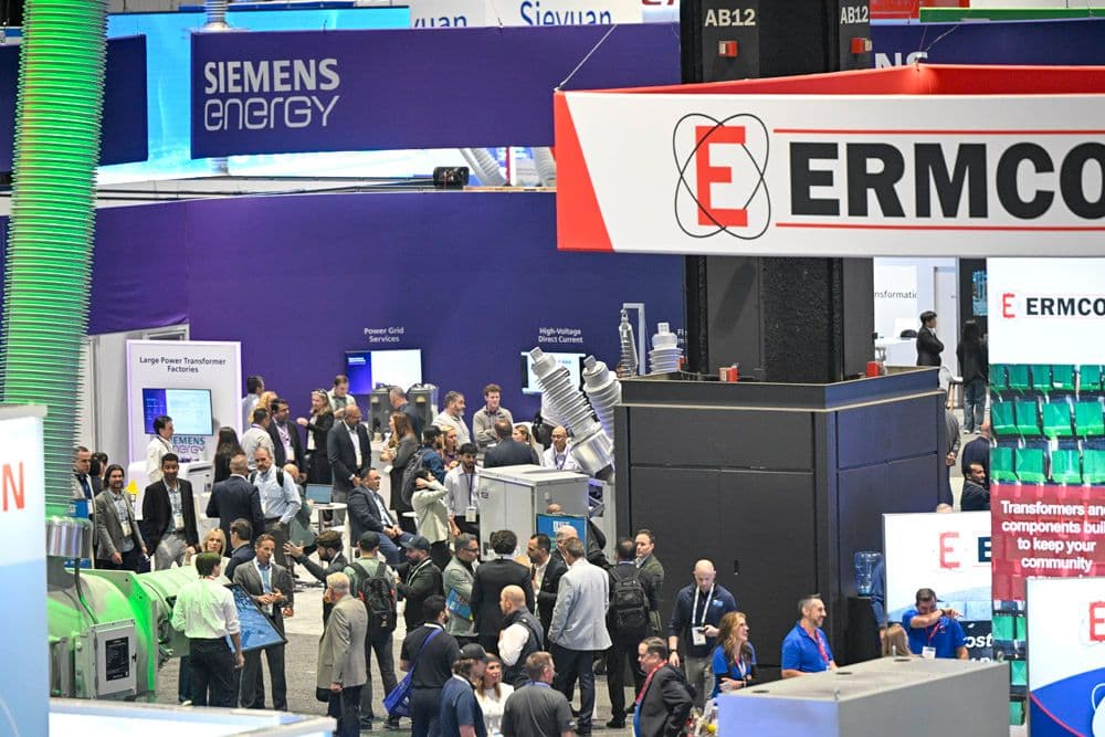 Crowded IEEE PES T&D 2026 exhibit floor with Siemens Energy and ERMCO booths