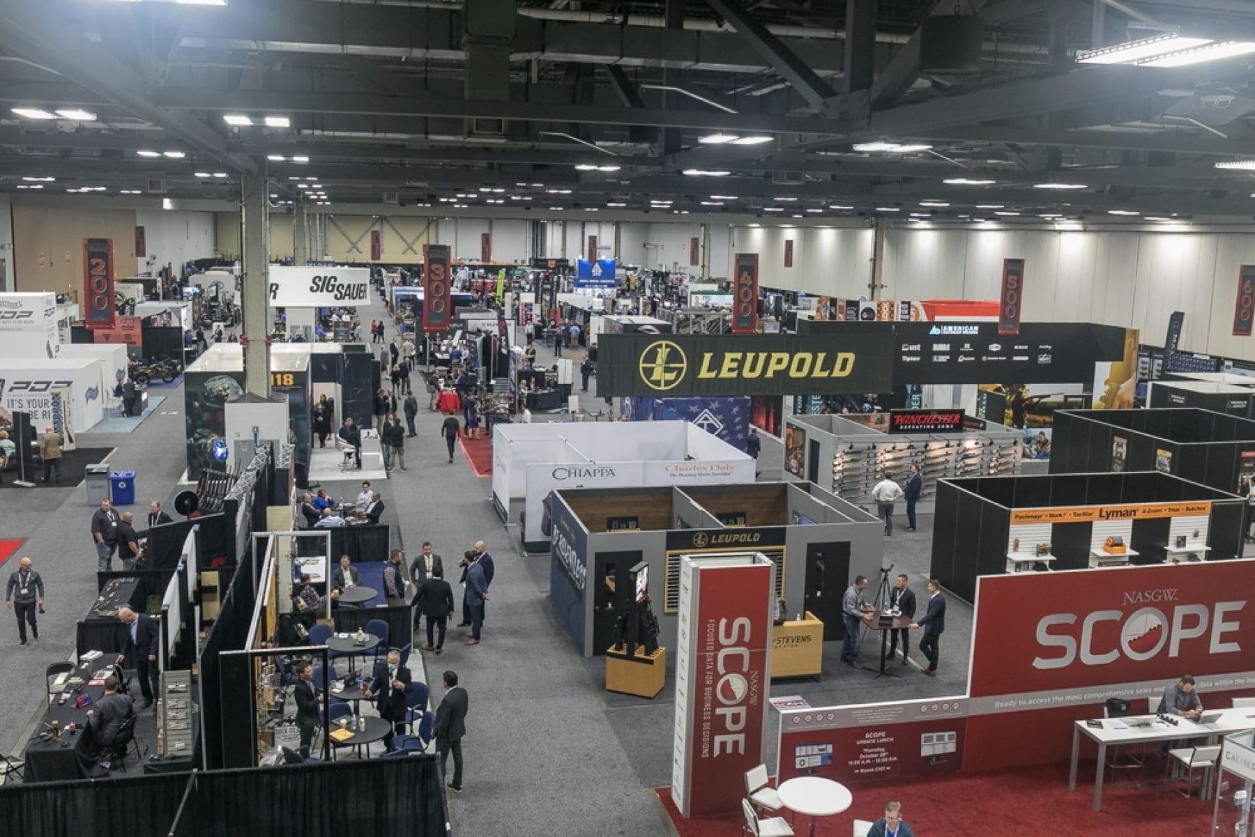 Overhead view of the NASGW Expo 2021 exhibit floor in Columbus, Ohio, with numbered aisle banners and the NASGW SCOPE booth