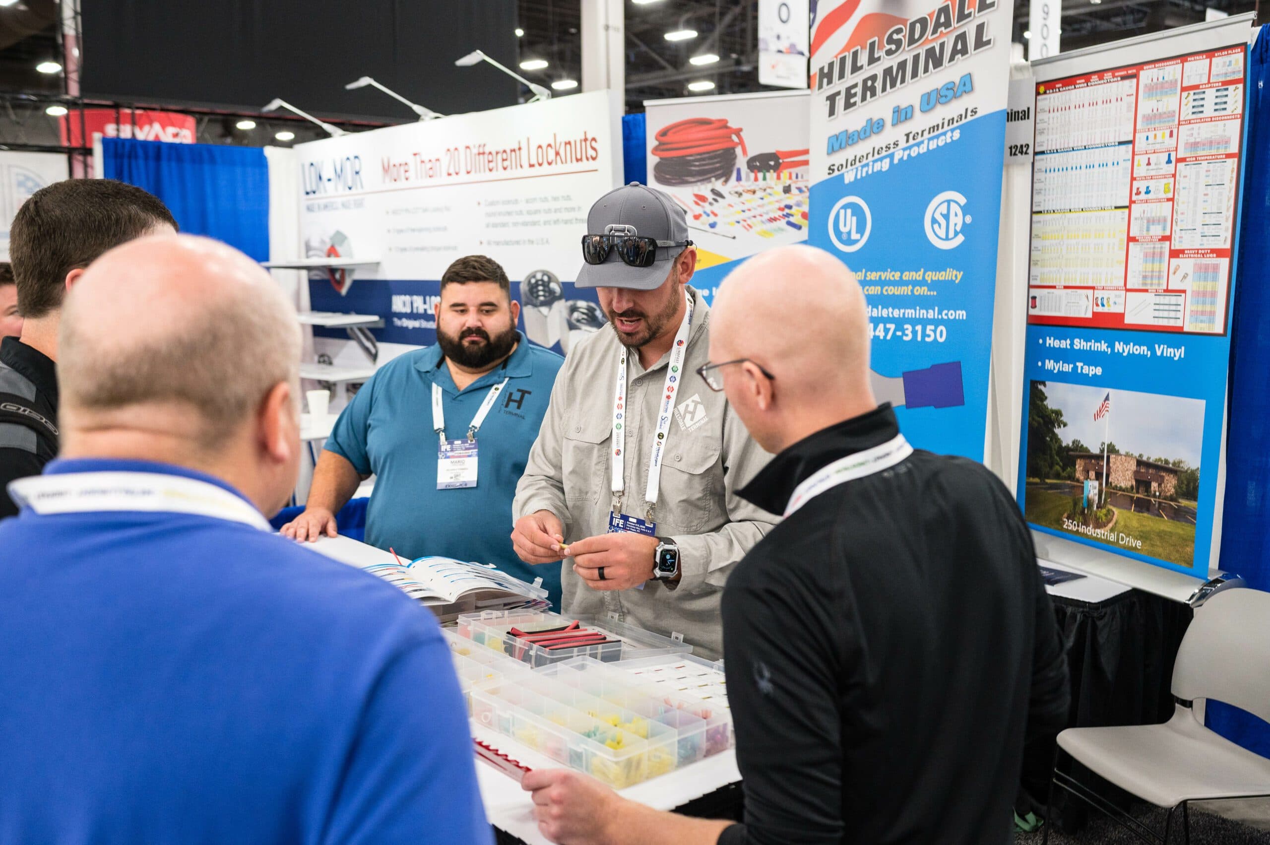 Attendees examining products at an International Fastener Expo booth in 2023