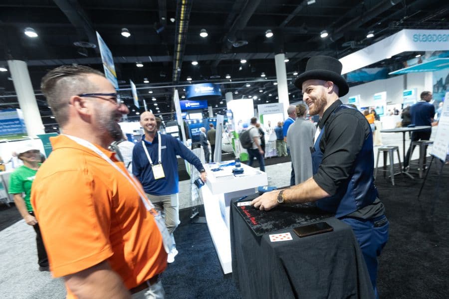 Expo performer engaging an attendee on the Community Summit North America 2025 floor