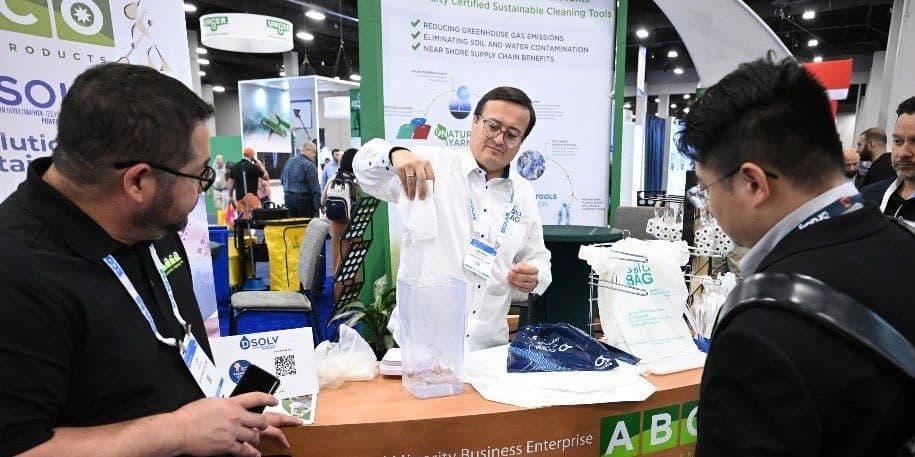Exhibitor demonstrates cleaning products to two attendees at the 2024 ISSA Show North America