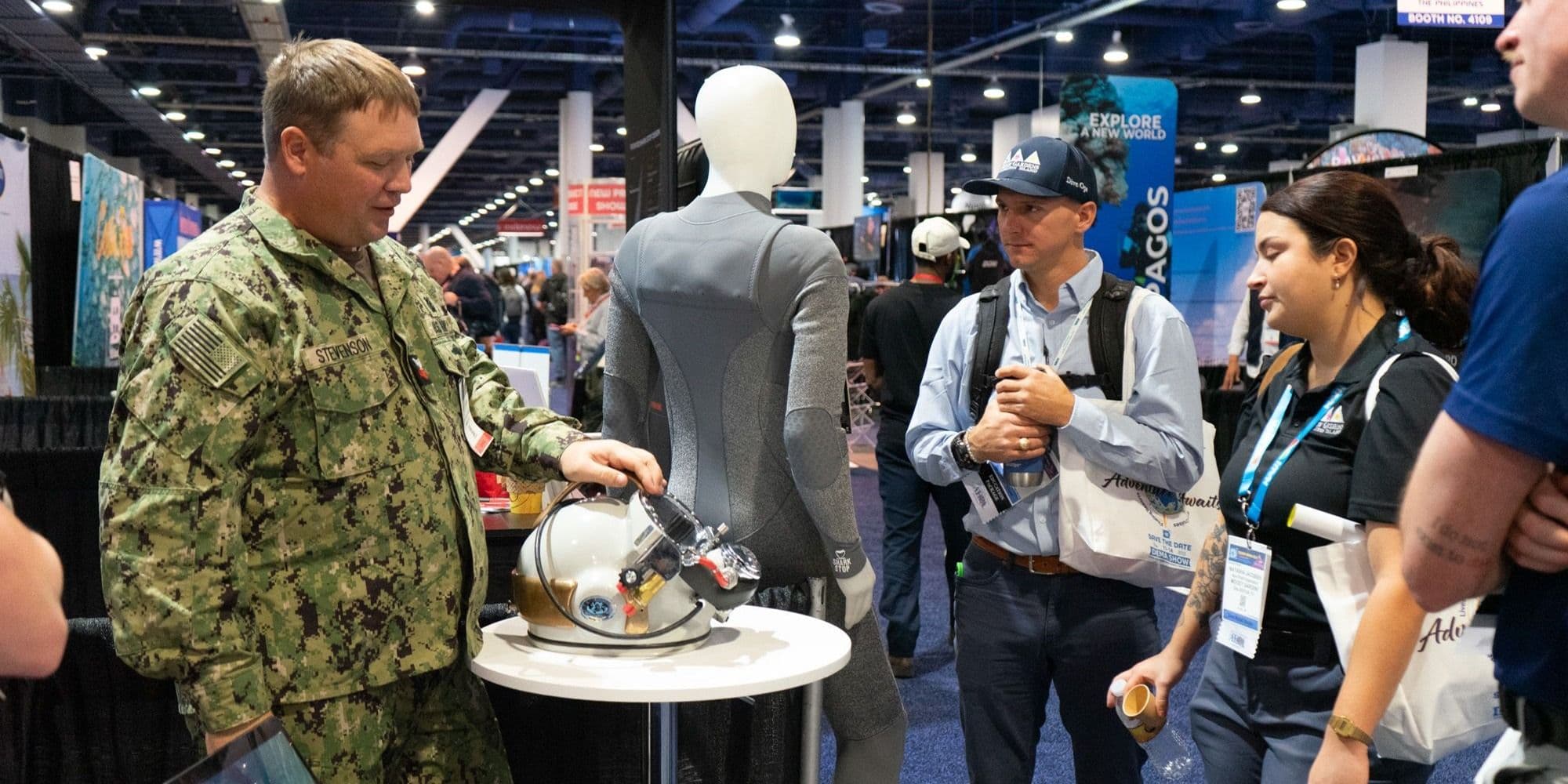 DEMA Show 2024 visitors looking at diving equipment on the floor